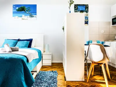 a bedroom with a bed and a desk and a chair at Apartment next to Wawel Castle, Vistula River & Old Town Cracow in Kraków