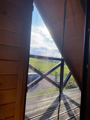 a view from the inside of a room with a window at Lawendowy Domek TP in Sułkowice
