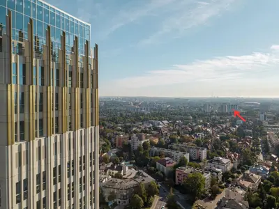 a red kite flying over a city at Mogilska Tauron Arena Two Bedroom Apartment in Kraków