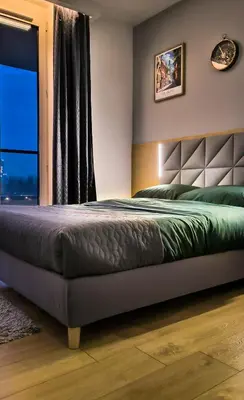 a bedroom with a bed and a window at Mogilska Tauron Arena Two Bedroom Apartment in Kraków