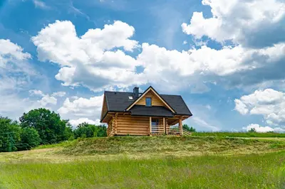a cabin on top of a hill in a field at Bacówka na Kubanówce in Rdzawka