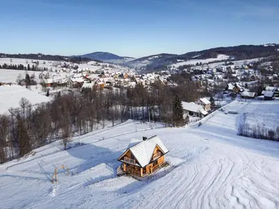 a log cabin in the snow in a town at Bacówka na Kubanówce in Rdzawka