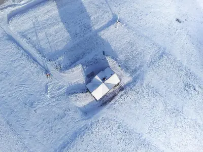 an aerial view of a white object in the snow at Bacówka na Kubanówce in Rdzawka