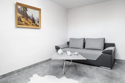 a living room with a couch and a table at Bacówka na Kubanówce in Rdzawka