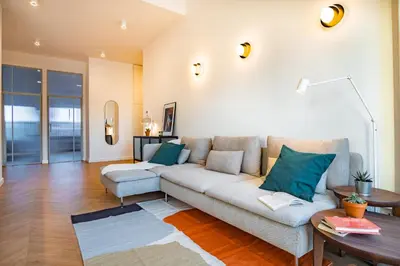 a living room with a couch and a table at Kossak 5 Suites in Kraków