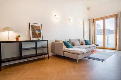 a living room with a couch and a table at Kossak 5 Suites in Kraków