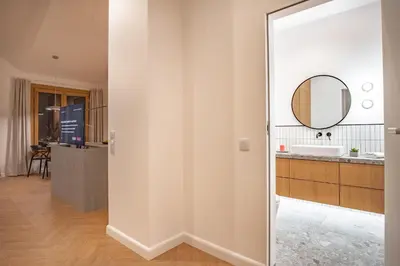 a bathroom with a mirror and a sink at Kossak 5 Suites in Kraków