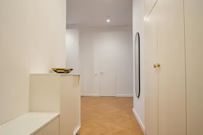 a white kitchen with a refrigerator in a room at Kossak 5 Suites in Kraków
