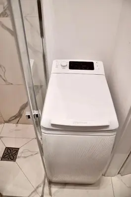 a white washer and dryer in a bathroom at Old Town Krakow in Kraków