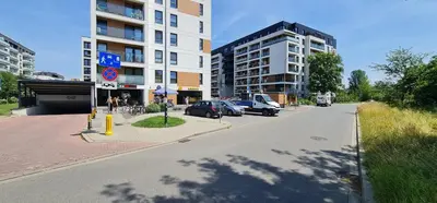a city street with cars parked in front of buildings at Dąbska Street Krakow - Luxury Apartments in Kraków