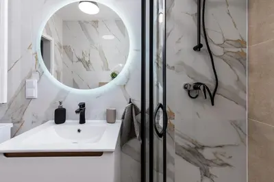 a bathroom with a sink and a mirror at Dąbska Street Krakow - Luxury Apartments in Kraków