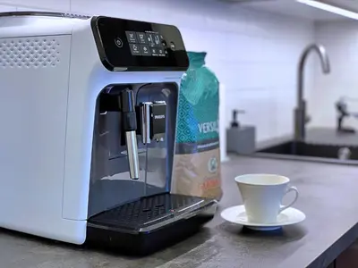 a coffee maker sitting on a counter with a coffee cup at Rzeszowska 5 Apt. 3 in Kraków
