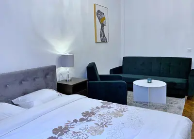 a bedroom with a bed and a chair and a table at Rzeszowska 5 Apt. 3 in Kraków