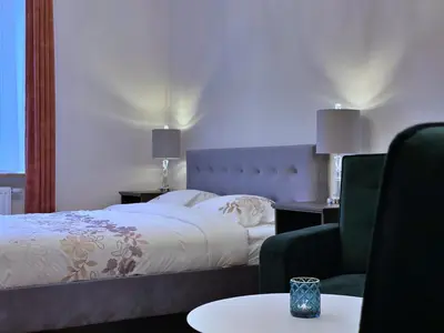 a living room with a couch and a bed and a table at Rzeszowska 5 Apt. 3 in Kraków