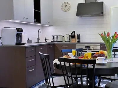 a kitchen with a table with a plate of fruit on it at Rzeszowska 5 Apt. 3 in Kraków