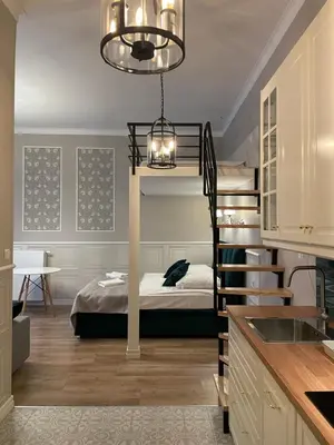 a room with a bunk bed and a kitchen at Starowiślna Center Apartments in Kraków
