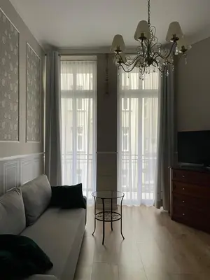 a living room with a couch and a table at Starowiślna Center Apartments in Kraków