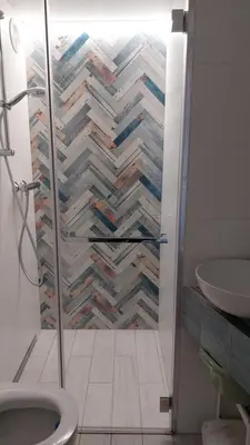 a bathroom with a shower with a toilet and a sink at Starowiślna Center Apartments in Kraków