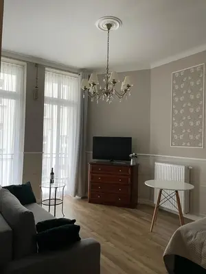 a living room with a couch and a flat screen tv at Starowiślna Center Apartments in Kraków