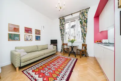 a living room with a couch and a table at Classy Old Town Suites - by Upstairs in Kraków