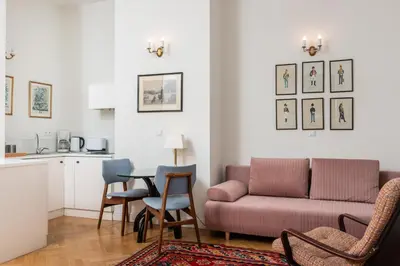 a living room with a couch and a table at Classy Old Town Suites - by Upstairs in Kraków