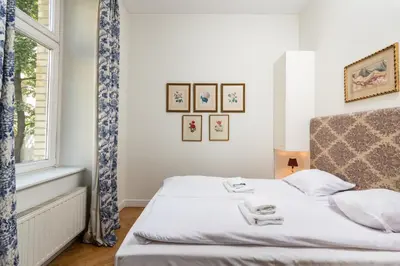 a bedroom with a bed and a window at Classy Old Town Suites - by Upstairs in Kraków