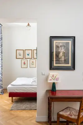 a bedroom with a bed and a table with a desk at Classy Old Town Suites - by Upstairs in Kraków