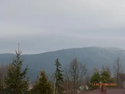 a mountain in the distance with trees in the foreground at Willa Roztoczanka in Rabka