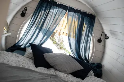 a bedroom with a bed and a window at Beczki Pod Lasem in Trzemeśnia