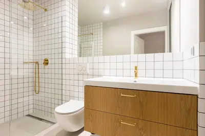 a white bathroom with a toilet and a sink at Family Apartment Nearto Old Town Vermelo by NEARTOpl in Kraków