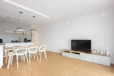 a living room with a table and chairs and a television at Family Apartment Nearto Old Town Vermelo by NEARTOpl in Kraków