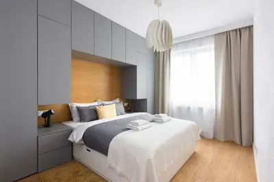 a bedroom with a large bed and a large window at Family Apartment Nearto Old Town Vermelo by NEARTOpl in Kraków