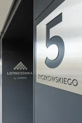 a sign for the company is displayed at a store at Lotniczówka Apartments by Renters Prestige in Kraków