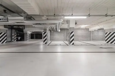 an empty parking garage with a room with black and white stripes at Lotniczówka Apartments by Renters Prestige in Kraków