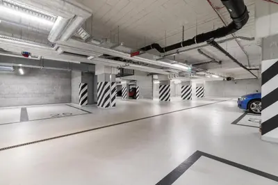an empty parking garage with a car parked in it at Lotniczówka Apartments by Renters Prestige in Kraków