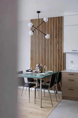 a dining room with a blue table and chairs at Lotniczówka Apartments by Renters Prestige in Kraków