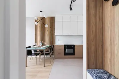 a kitchen with a table and a dining room at Lotniczówka Apartments by Renters Prestige in Kraków