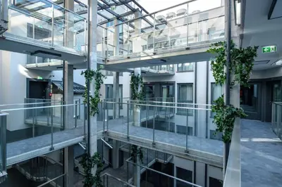 an apartment building with plants on the balconies at Xerion Hotel in Kraków