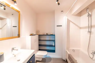 a bathroom with a sink and a toilet and a tub at Apartament Chmielna Gold in Kraków