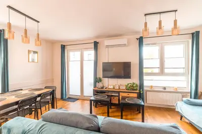 a living room with a couch and a table at Apartament Chmielna Gold in Kraków