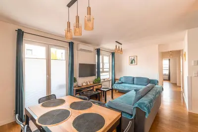 a living room with a couch and a table at Apartament Chmielna Gold in Kraków