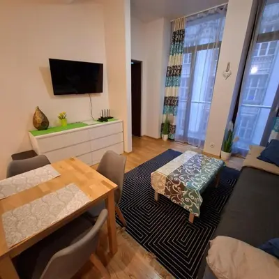 a living room with a couch and a table at Apartament Wielopole 17 in Kraków