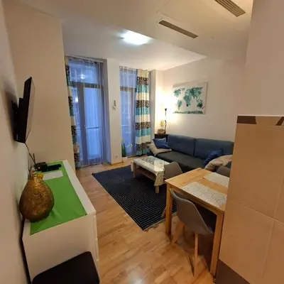 a living room with a couch and a table at Apartament Wielopole 17 in Kraków