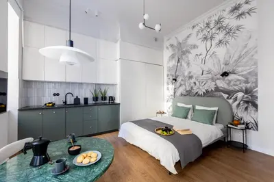a bedroom with a bed and a table with food on it at LION apartments - Premium STUDIO with BALCONY in Kraków