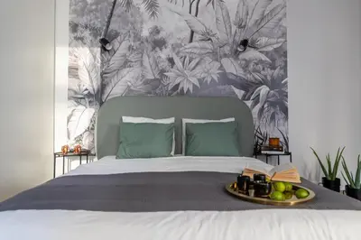 a bed with a tray of fruit on top of it at LION apartments - Premium STUDIO with BALCONY in Kraków