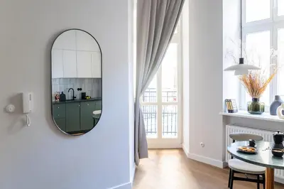 a living room with a mirror and a table at LION apartments - Premium STUDIO with BALCONY in Kraków