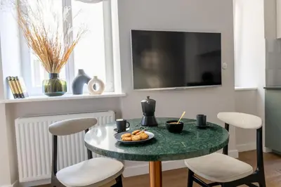 a table with a plate of food on it in a kitchen at LION apartments - Premium STUDIO with BALCONY in Kraków