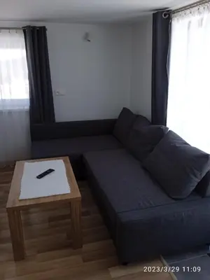 a blue couch in a living room with a table at Dwa Widoki Apartamenty in Zubrzyca Górna