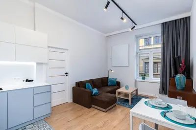 a living room with a couch and a table at St. Florian cozy loft in Kraków
