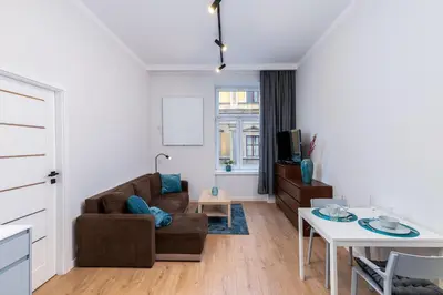 a living room with a couch and a table at St. Florian cozy loft in Kraków